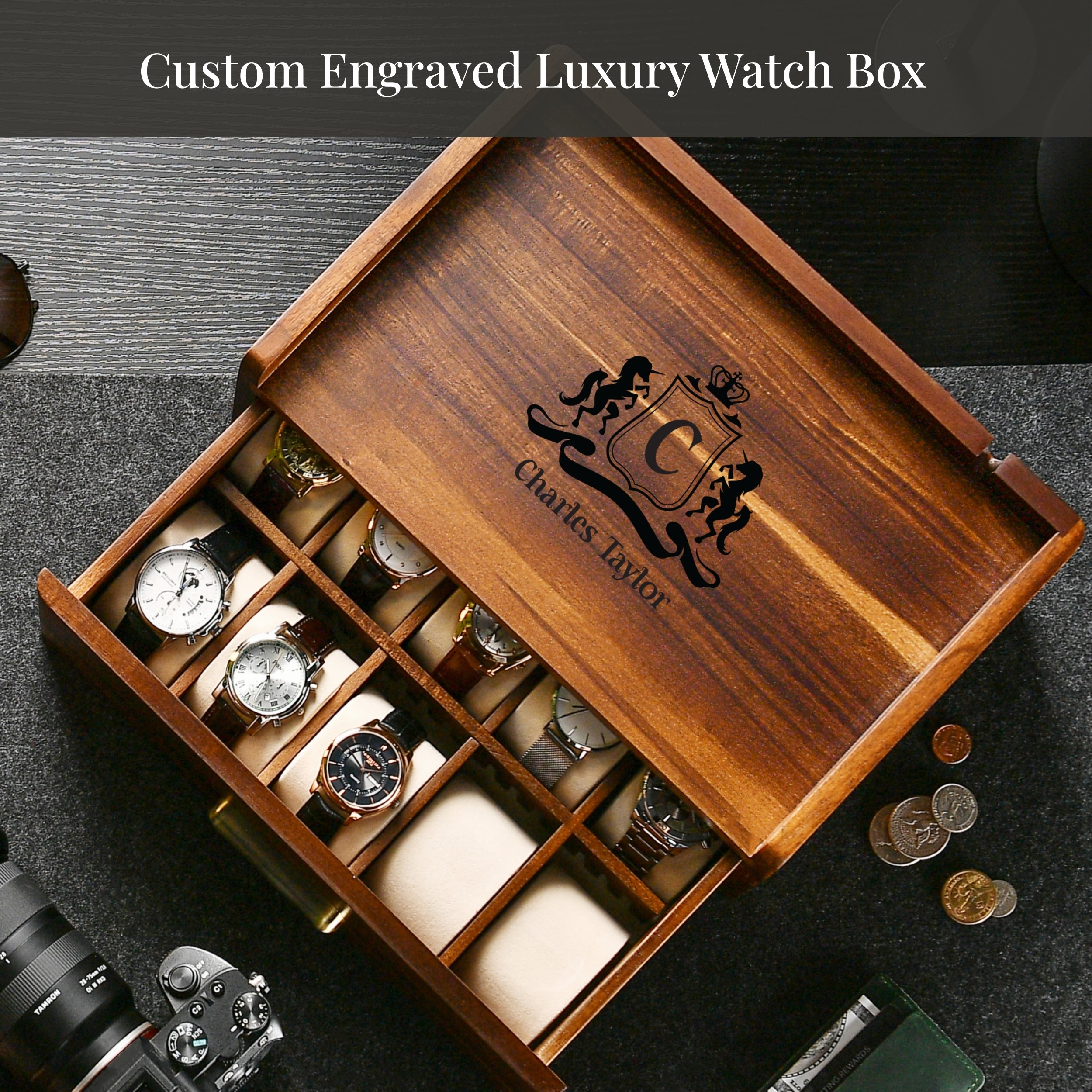 A wooden watch box with a personalized monogrammed logo, containing various watches and a camera.