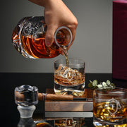 a person pouring a drink into a glass