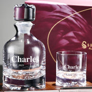 a bottle and a glass sitting on a table