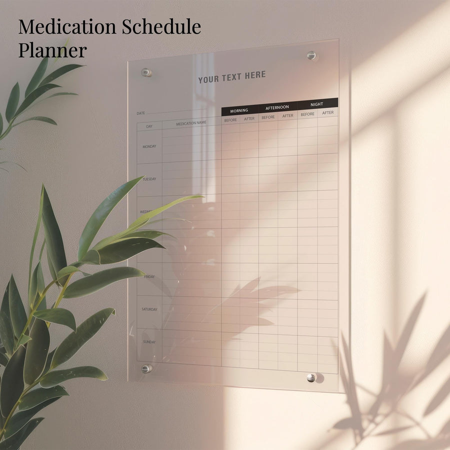 a medication schedule planner hanging on a wall, with a plant in the foreground.