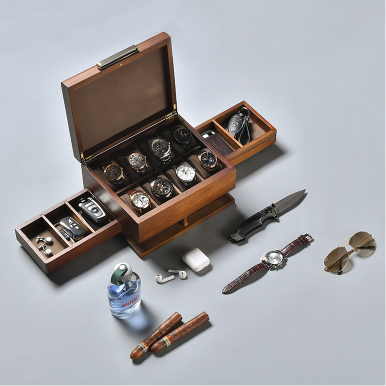 a wooden box with multiple compartments, containing various items such as watches, sunglasses, a knife, and other accessories.