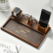 a wooden tray with glasses, a cell phone, and a pair of glasses