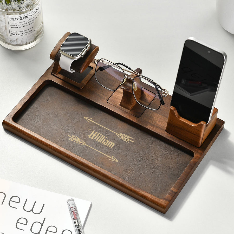 a wooden tray with glasses, a cell phone, and a pair of glasses