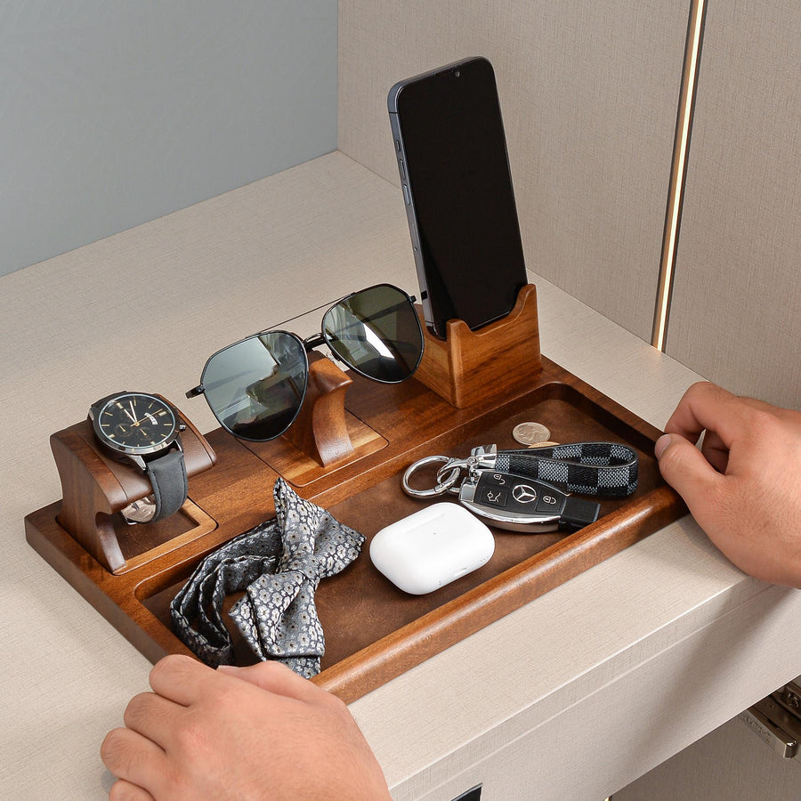 a person holding a mouse and a cell phone on a desk