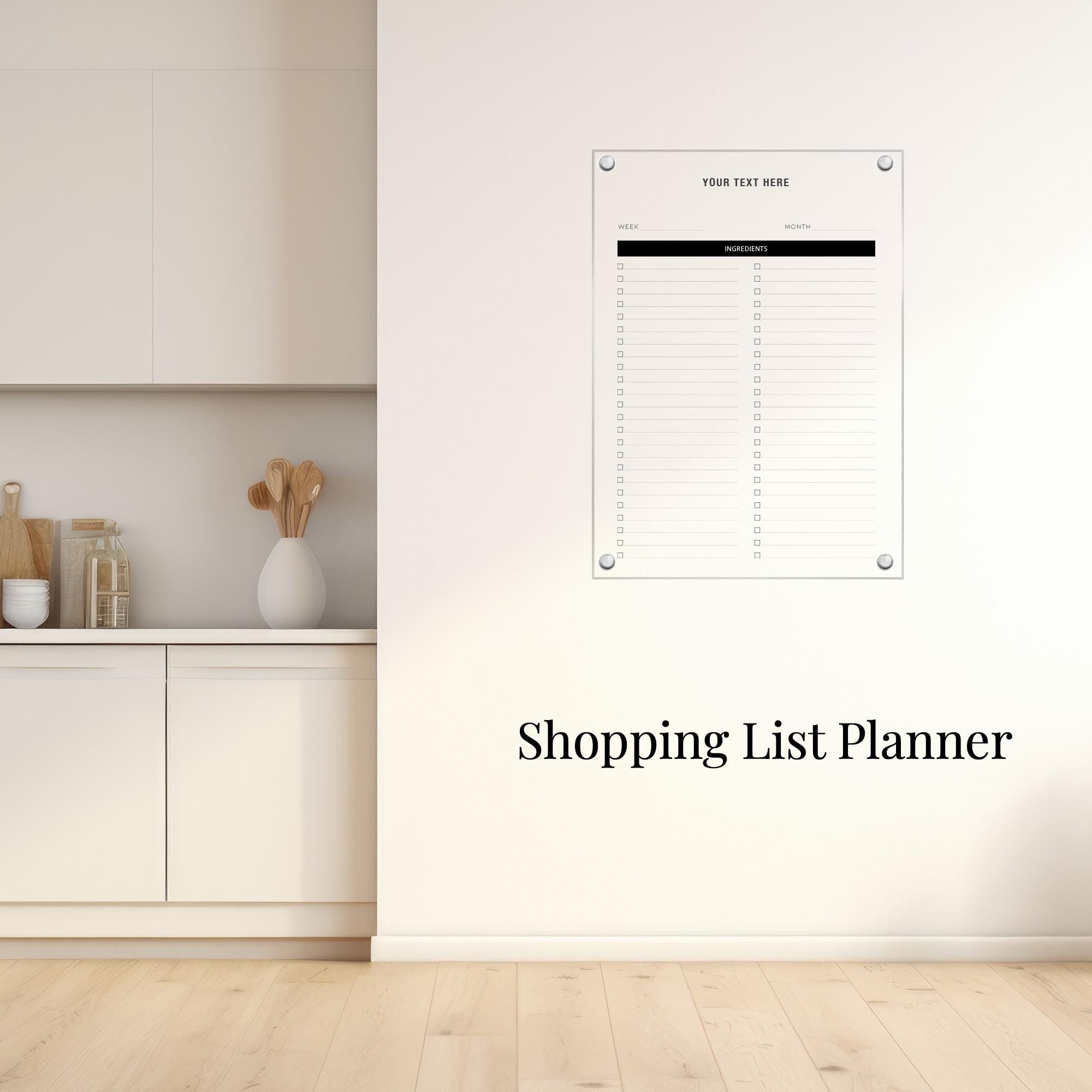 a white kitchen counter with a vase of spoons, a shopping list planner hanging on the wall, and a wooden floor.