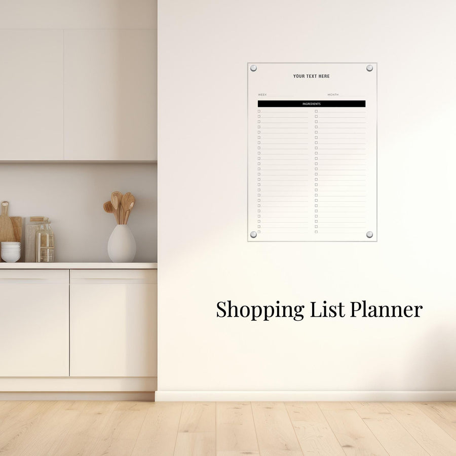 a white kitchen counter with a vase of spoons, a shopping list planner hanging on the wall, and a wooden floor.