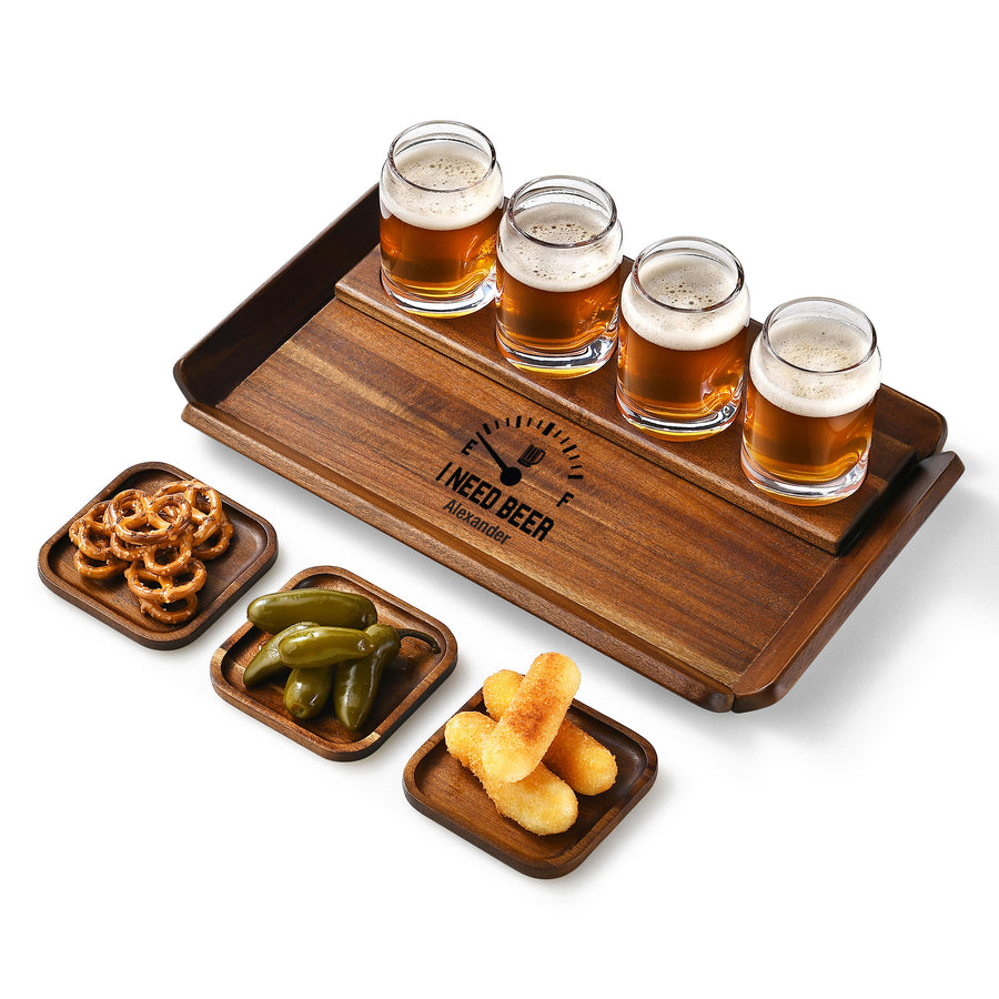 A wooden tray with four glasses of beer, three small plates with snacks, and a logo on the tray.