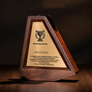 a wooden award plaque sitting on top of a wooden table