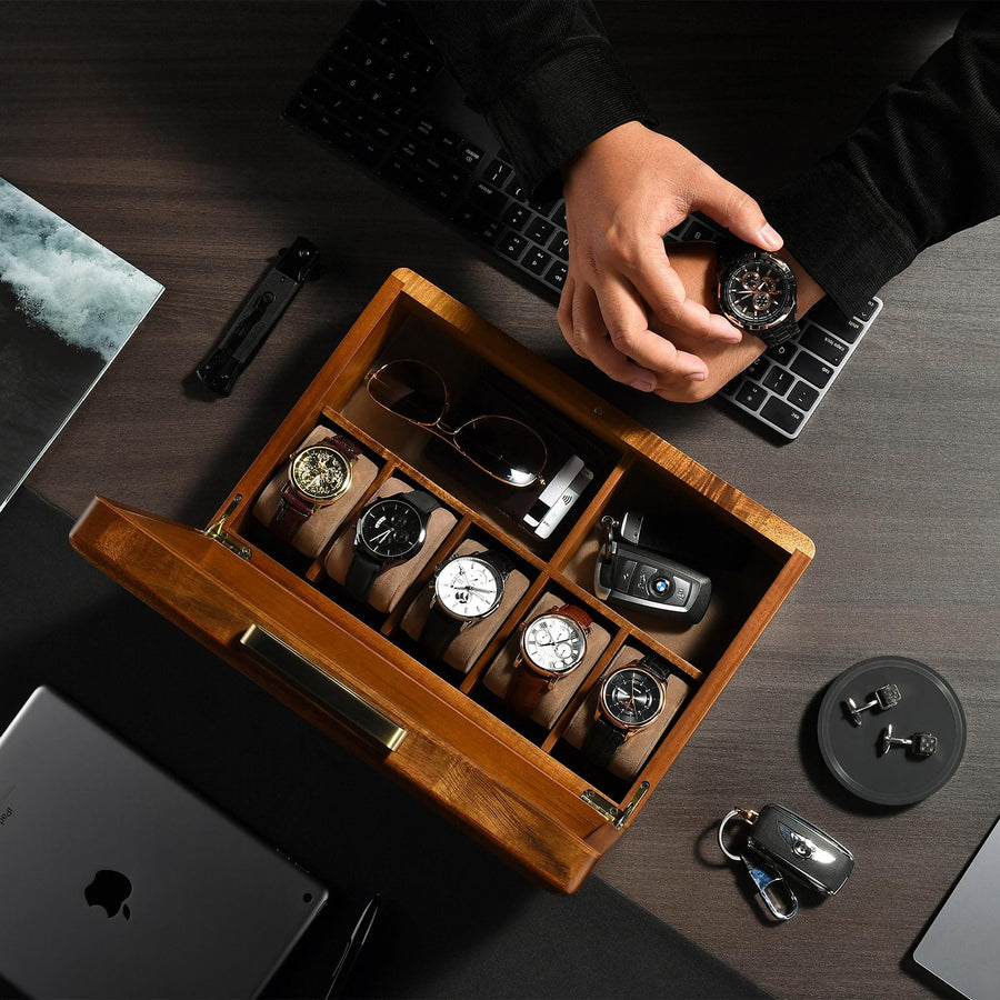 a person holding a watch in a wooden box