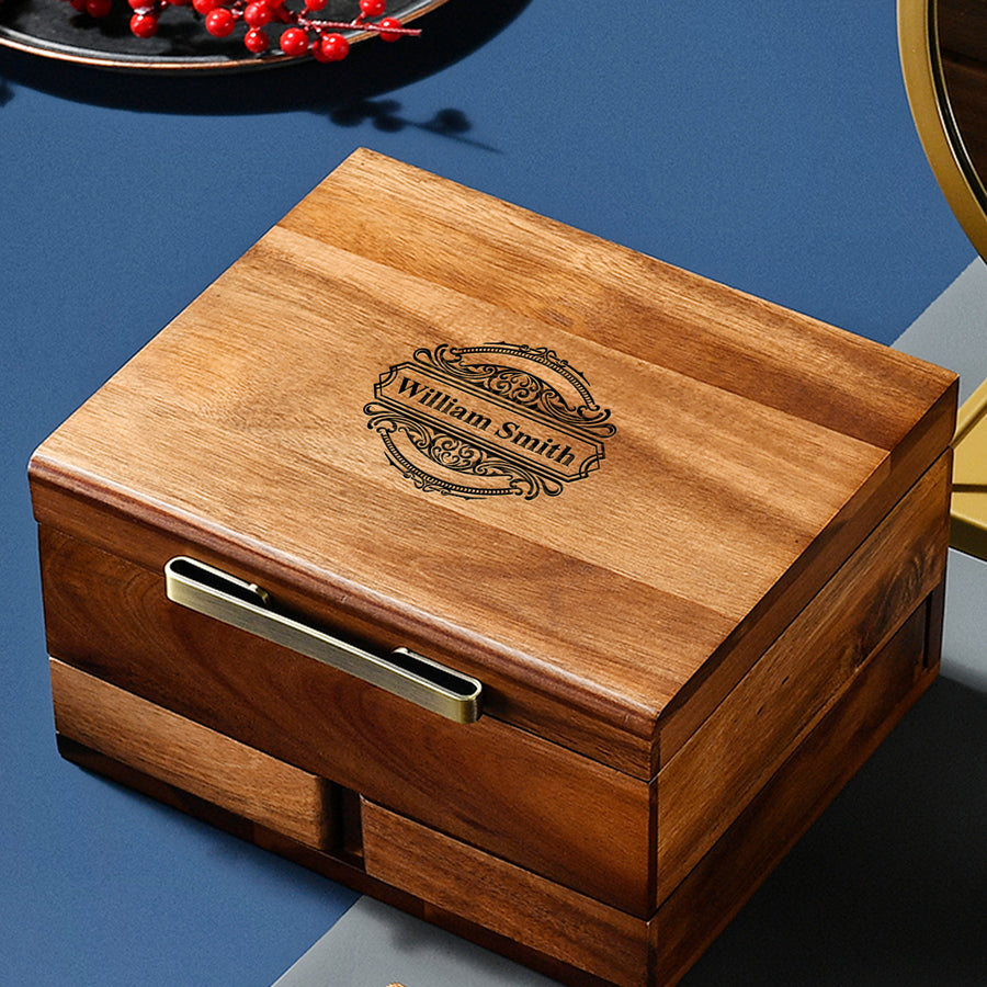 A wooden box with a decorative embossed nameplate, sitting on a blue surface.